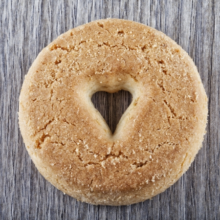 A biscuit with a hole in shape of heart in the centerの写真素材