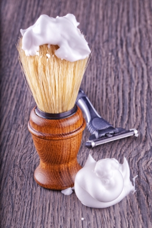 Close up of foam and brush, with razor on the backの写真素材