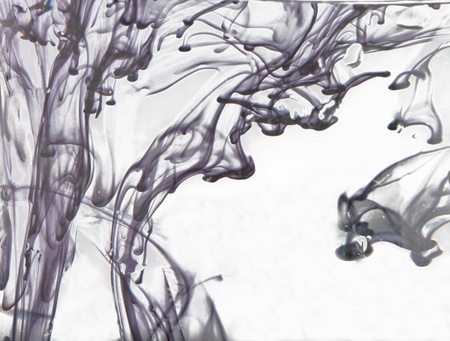 Black ink floating in the white water