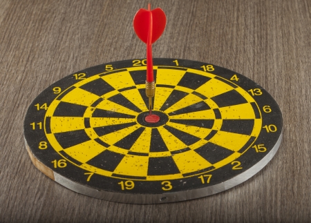 A black and yellow target with arrow on the centerの写真素材