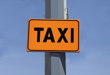 Big orange cartel with signal of taxiの写真素材