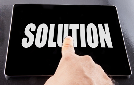 Male hand touching black tablet with word Solution