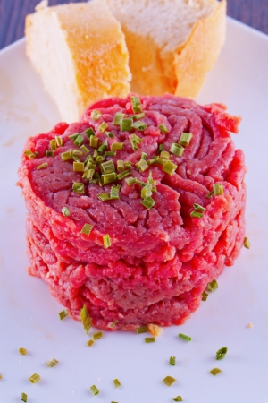 Close up of fresh ground beef over a white plateの写真素材