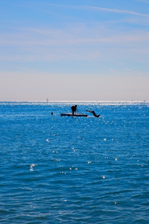 people diving from a platform in the seaの写真素材