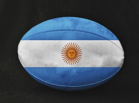 Rugby ball with Argentina flag, over black backgroundの写真素材