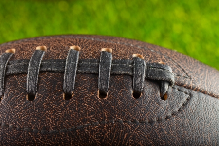 Leather Football in strict closeup with grass in the backの写真素材