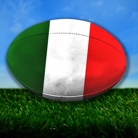 Rugby ball with Italy flag over grassの写真素材