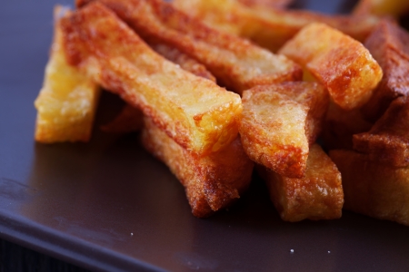 Close up of fried potatoes over a brown plateの写真素材