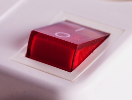 Red switch of a multiple electrical socket in closeupの写真素材