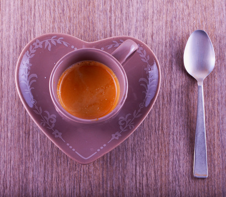 Coffee cup with heart shaped plate, from aboveの写真素材