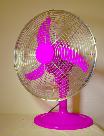 Pink fan with metallic grid over tableの写真素材