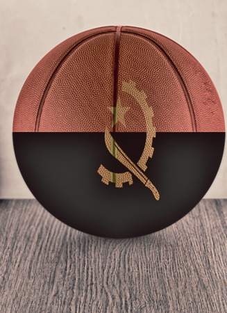 Basketball with flag of Angola, over wooden surfaceの写真素材