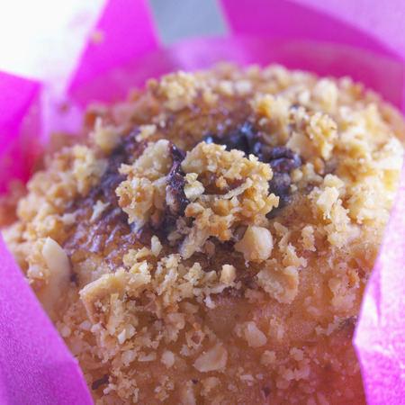 Chocolate muffin inside white and pink paper, strict close upの写真素材