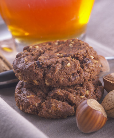 Biscuits in between tea, almond and nutsの写真素材
