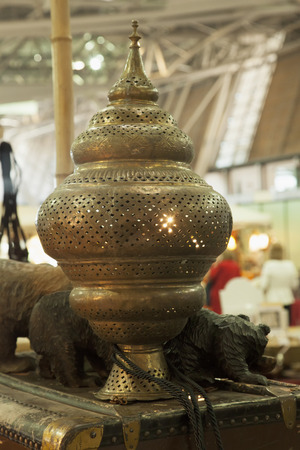 Oriental golden lamp over wooden cask, vertical imageの写真素材
