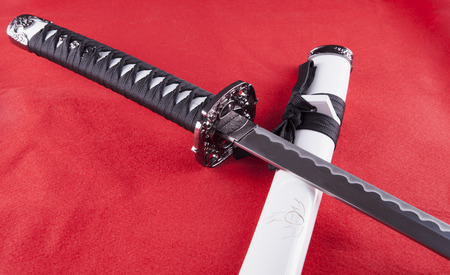 Katana over white custody, red background, horizontal imageの写真素材