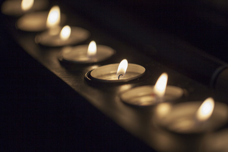 Candles in a row, with focus in central oneの写真素材