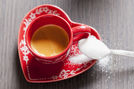 Coffee in a red cup, over wooden table, horizontal imageの写真素材