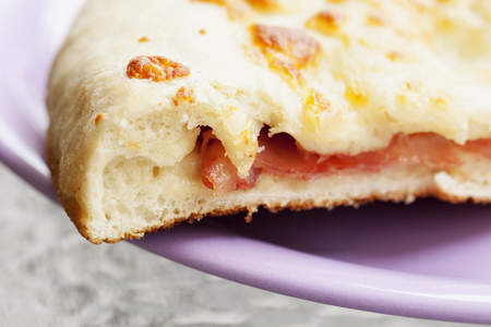Focaccia with tomatoes over purple plate, horizontal imageの写真素材