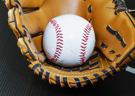 Baseball in glove, close up, horizontal image