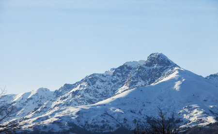 Snowy mountain top, landscape, blue sky, horizontal imageの写真素材