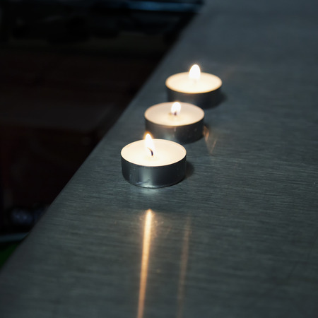 Candles over metal bar counter, square imageの写真素材