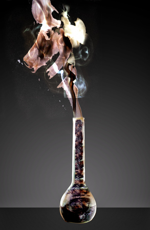 Magic bottle fluid, over dark background, vertical imageの写真素材