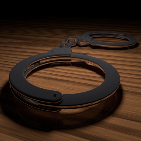 Metal handcuffs over wooden table, 3d renderingの写真素材