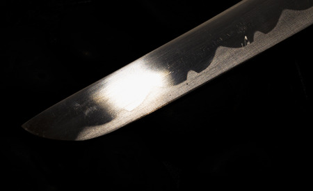 Blade shining in the darkness, horizontal image