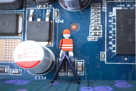 Worker puppet on a computer motherboard, 3d renderingの写真素材