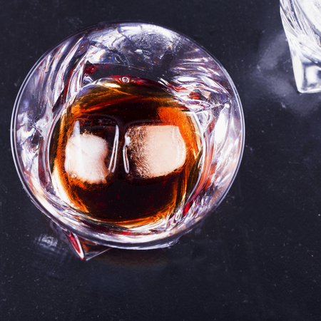 Glass with liquor and ice, square imageの写真素材