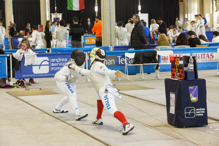 CASALE MONFERRATO, ITALY - FEBRUARY 25, 2017: Fencers in a match at Italian fencing Championships in...