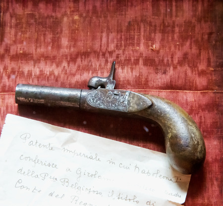 MARCH 25, 2018 - MASINO, ITALY: small revolver with imperial note of Napoleon I in Masino Castle, Piedmont, Italyのeditorial素材