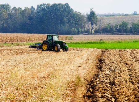 Tractor working on the fields, Horizontal imageのeditorial素材