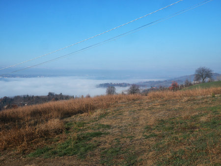 Foggy landscape of hills under blue sky, landscape viewの写真素材