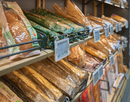 Different types of bread on shelves in supermarket.の写真素材