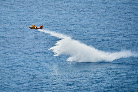 Aerobatic plane in the blue sea with white foam.の写真素材