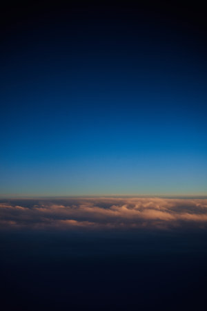 Cloudscape, Colored Clouds at Sunset near the Ocean, View from Planeの写真素材