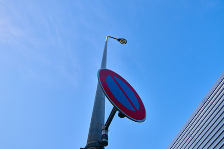 Road sign on blue sky background. Street light pole with traffic sign.の写真素材