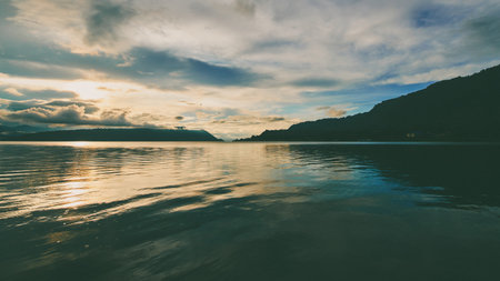 Beautiful sunset over the lake in the mountains. Toned.の写真素材
