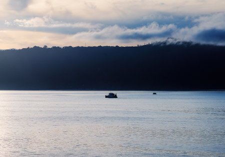 Fishing boat on the sea at sunset. Silhouette of a fishing boat.の写真素材