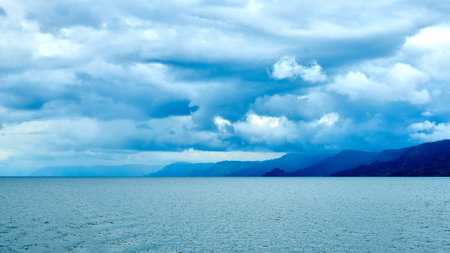 cloudy sky over the sea and mountains, natural landscape background.の写真素材
