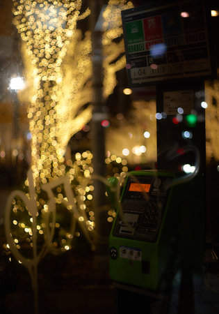 Parking ticket machine in the city at night with bokehの写真素材