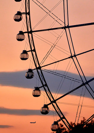 Silhouette of Ferris wheel at sunset, closeup of photoの写真素材