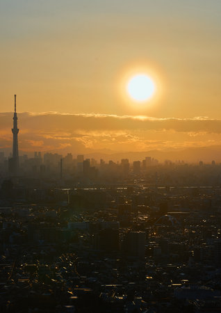 Tokyo city skyline at sunset with Tokyo Skytree in background.の写真素材