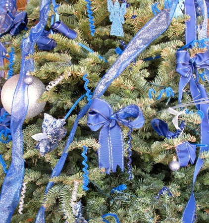 Silver balls and blue ribbons on the Christmas treeの写真素材