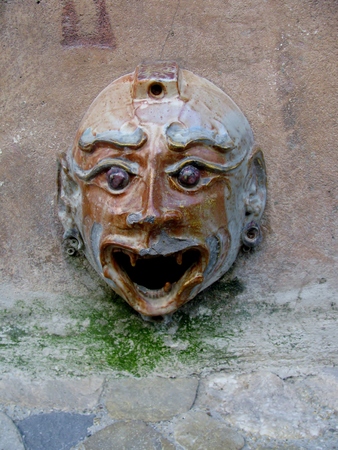 Old mask as a decorative gutter downspoutsの写真素材