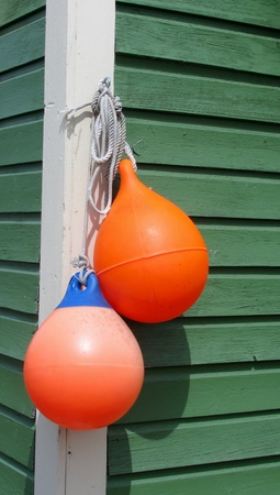 Colorful floats hanging on shed wallの写真素材