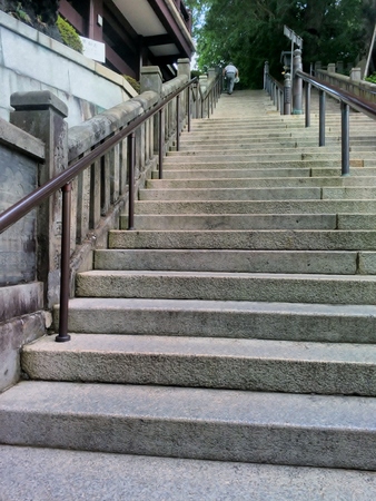 Senior man climbing up long stairs. Tokyo, Japan