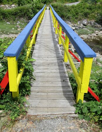 Colorful footbridge over small stream. Hospital Bay, Pender Harbour, Madeira Park, Sunshine Coast, BC, Canadaの写真素材
